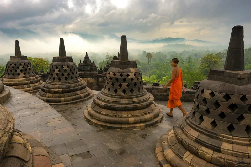 Carved stone narrative relief panels lining a gallery wall at Borobudur Temple, Central Java
